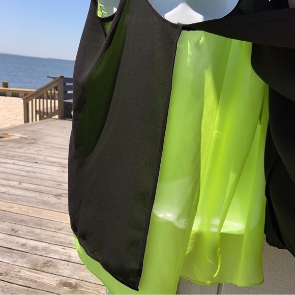 Black and chartreuse glossy top with adjustable straps, and a flowing open back. - Picture 3 of 5
